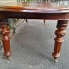 A 19th Century Antique Victorian Mahogany Extending Dining Table with Heavily Carved Legs on Brass Castors - Image 6