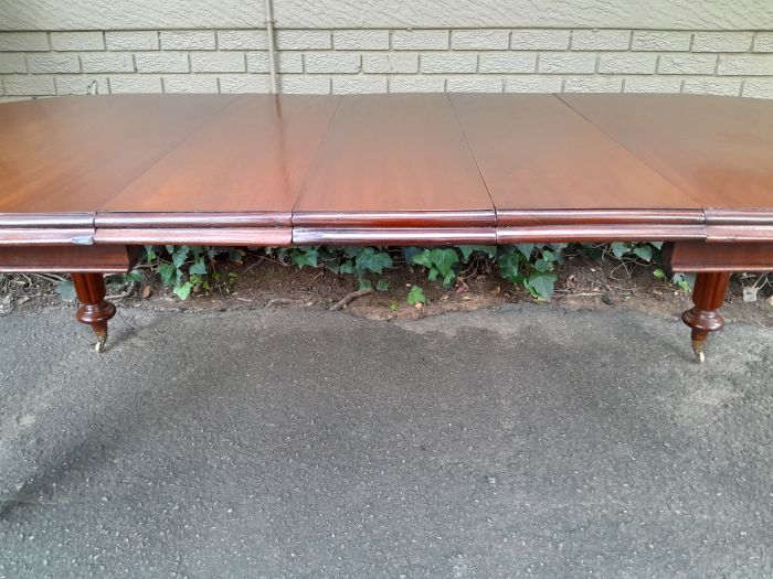 A 19th Century Antique Victorian Mahogany Extending Dining Table with Heavily Carved Legs on Brass Castors - Image 7