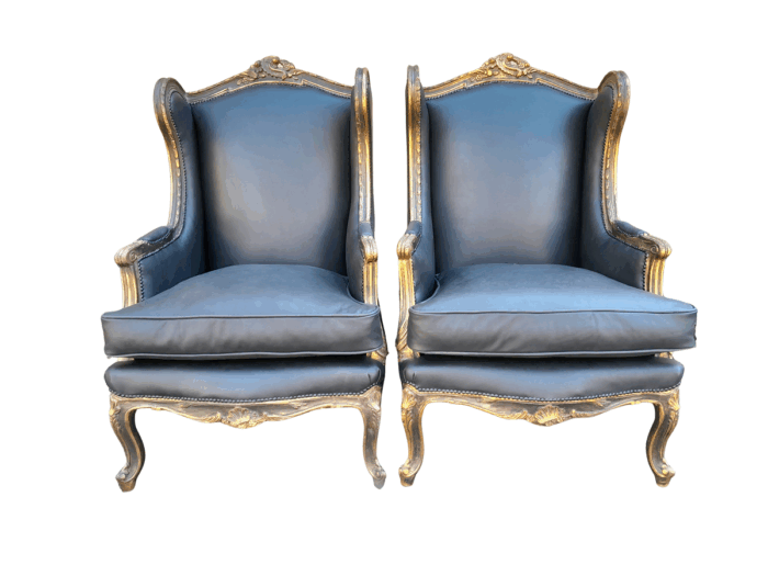 A Circa 1900s French Style Pair Of Carved Giltwood Wingback Chairs Upholstered In Leather