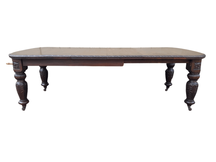 An Antique Victorian English Carved Oak Extending Dining Table on Castors and with Crank Handle