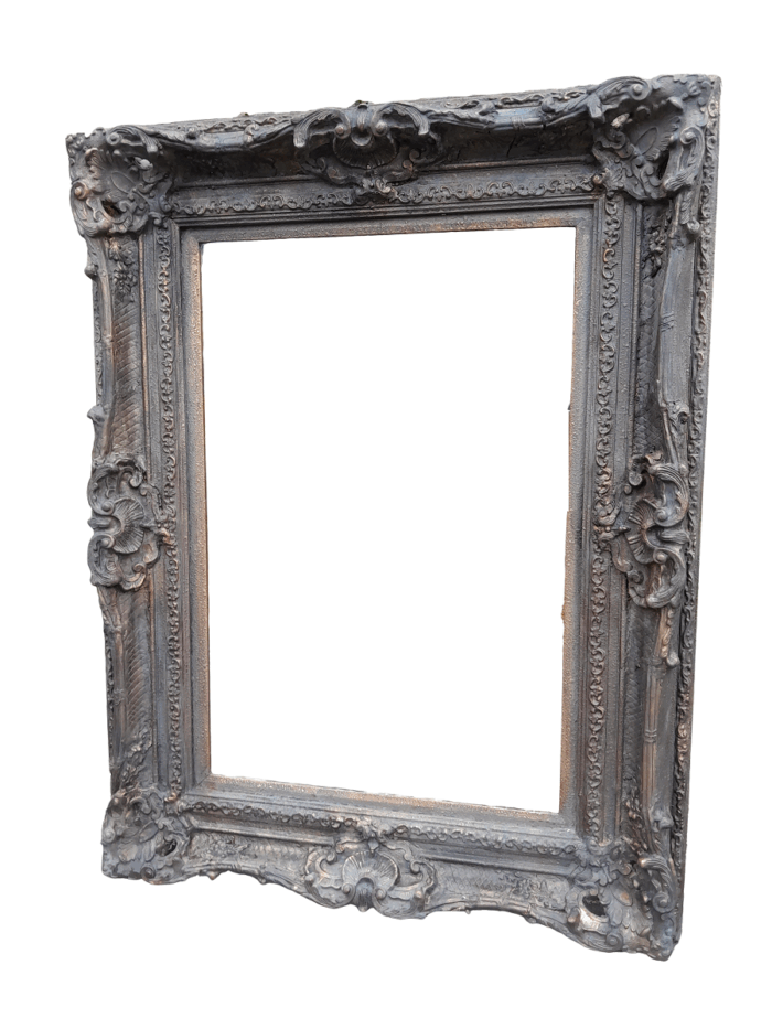 A 20th Century French Style Heavily Carved And Gilded Mirror