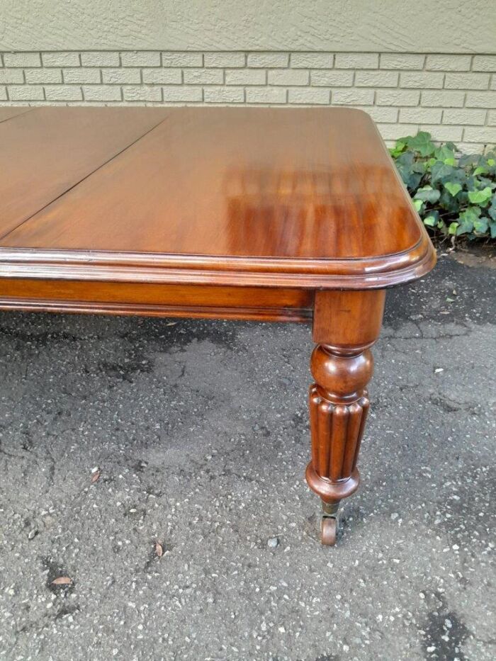 An Antique Edwardian Extending Dining Table with Heavily Carved Legs on Castors and with Crank Handle - Image 6