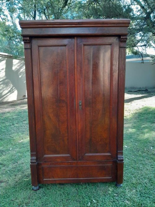 A Mid  20th Century Stinkwood Linen Press with Four Original Shelves and Drawers