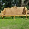 A 20th Century French Style Carved and Gilded Conversation Settee in Rattan