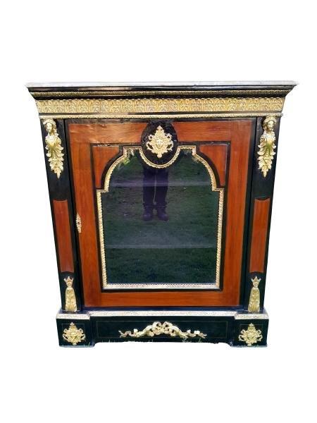 A 20th Century French Style Mahogany And Ebonised Pier Cabinet With Marble Top And Brass Hardware And Bevelled Glazed Door With Shelves