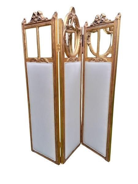 A French Style Ornately Carved Giltwood With Bevelled Mirror Screen Upholstered In An Ivory Linen