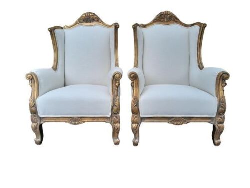 An Ornately Carved Pair Of Giltwood Chairs Upholstered In Leather