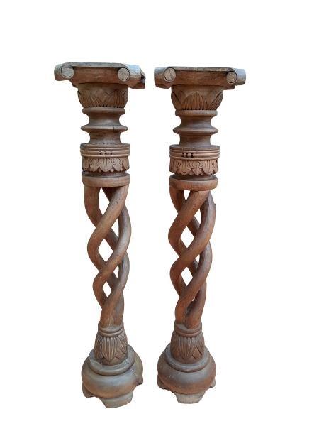 An Ornately Carved Wooden Pair Of Candle Holders In A Contemporary Bleached Wood Finish