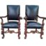 A 20th Century Pair Of Throne Style Teak And Mahogany Chairs Upholstered In Leather