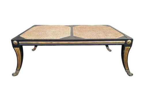 A Rattan Black and Gilded Coffee Table on Castors