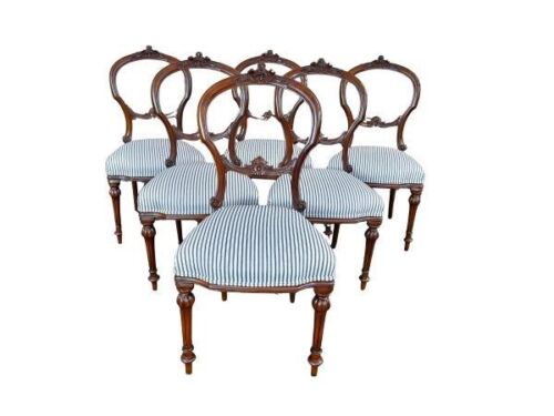 A Late 19th Early 20th Century Victorian Set Of Six Carved Walnut Bustle-Back Dining Chairs With Floral Upholstery