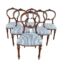 A Late 19th Early 20th Century Victorian Set Of Six Carved Walnut Bustle-Back Dining Chairs With Floral Upholstery