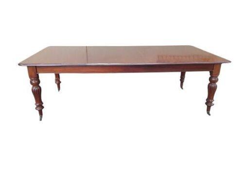 A Late 19th Early 20th Century Victorian Mahogany Dining Table With Brass Casters