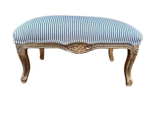 A French Style Gilded Ottoman Upholstered In A Ticking Stripe