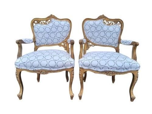 A 20th Century Pair of French Rococo Style Ornately Carved Giltwood Arm Chairs Upholstered in Designer Linen