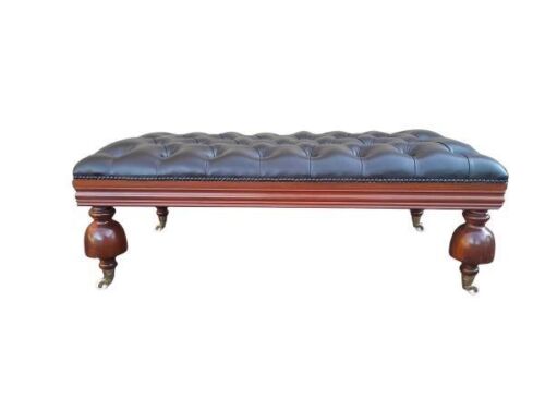 A 20th Century Ottoman With Wooden Legs On Castors Upholstered In Deep Buttoned Leather