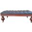 A 20th Century Ottoman With Wooden Legs On Castors Upholstered In Deep Buttoned Leather