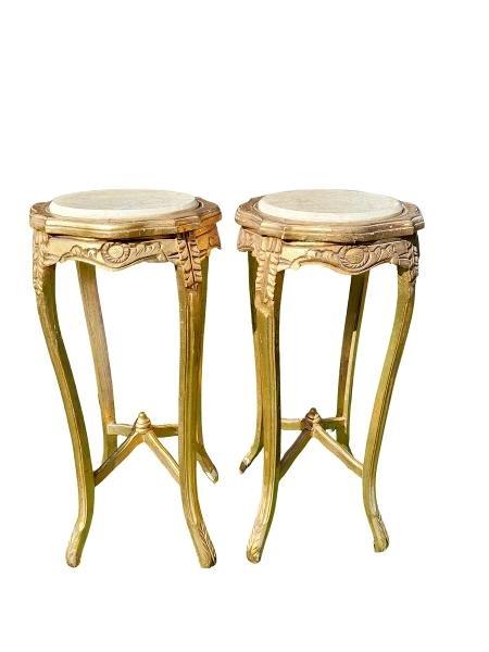 A Pair Of French Style Ornately Carved Giltwood Tables With Cream Marble Tops