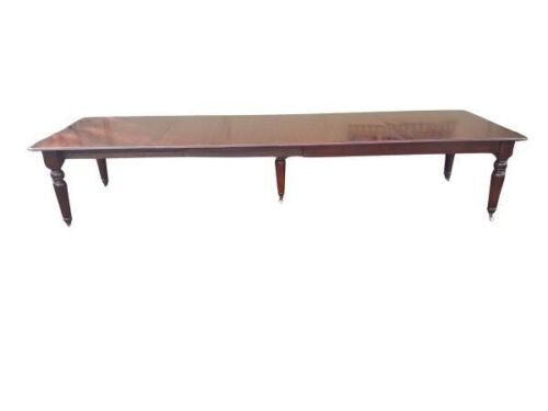 A Massive Antique Victorian Mahogany Extension Dining Table On Five Legs With Original Porcelain Castors