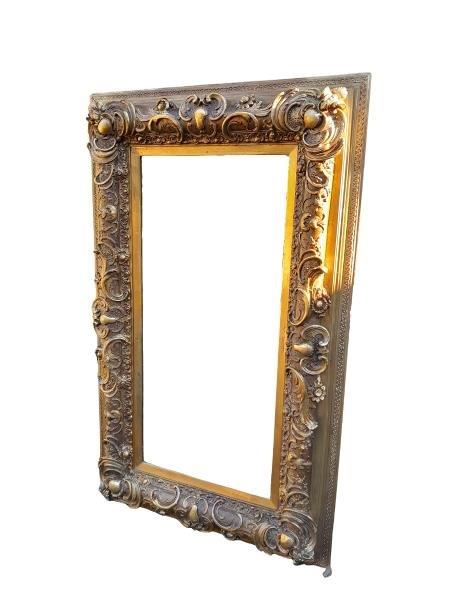 A 20th Century Ornately Carved And Bevelled Mirror