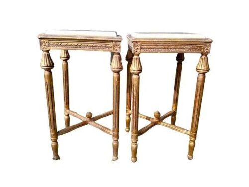 A Pair Of French Style Ornately Carved Giltwood Tables With Cream Marble Tops