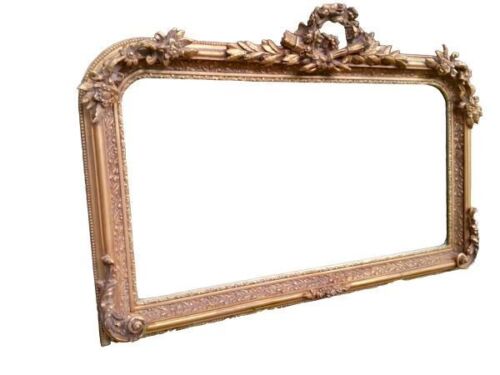 An Ornate Rococo Style Carved Giltwood And Bevelled Mirror