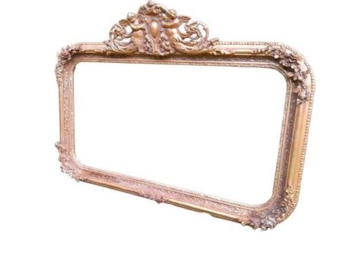 An Ornate Rococo Style Carved Giltwood And Bevelled Mirror