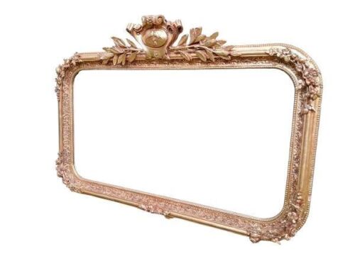 An Ornate Rococo Style Carved Giltwood And Bevelled Mirror