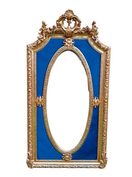 An Ornate Rococo Style Carved Giltwood And Bevelled Mirror With Royal Blue Suede Inner Lining