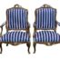 A French Style Pair of Ornately Carved Giltwood Armchairs of Large Proportions Upholstered in Original Fabric