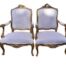 A French Style Pair of Ornately Carved Giltwood Armchairs of Large Proportions Upholstered in Original Fabric