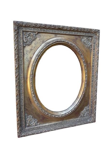A 20th Century Ornately Carved Giltwood And Bevelled Mirror