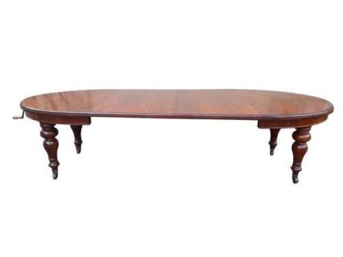 An Antique 19th Century Circa 1880 to 1890 Victorian Mahogany Extension Dining Table with Three Extension Leaves and Crank Handle on Brass and Porcelain Castors