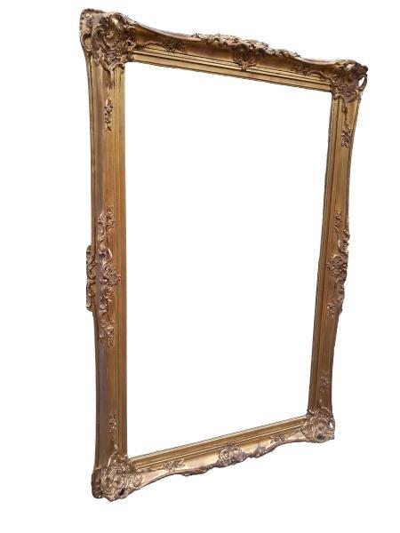 A 20th Century Large And Heavily Carved Giltwood Framed Bevelled Mirror