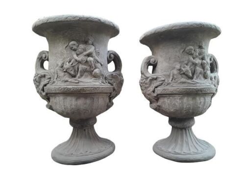 A Pair Of Massive Concrete Urns  With Cherubs In An Antique Aged Finish