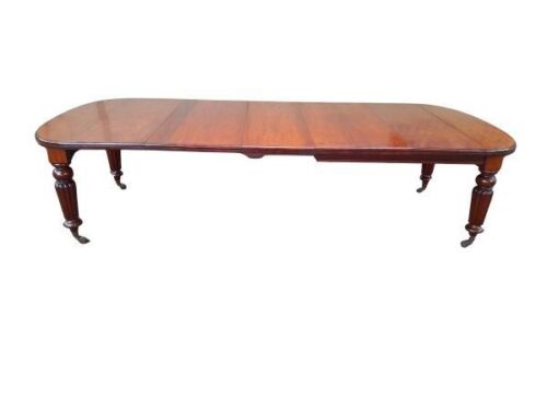 An Antique Victorian Carved Mahogany Dining Table With Castors And Crank