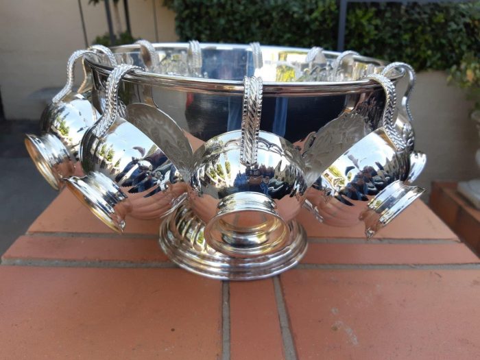 A Silverplate Punch Bowl With Twelve Cups