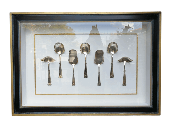 A Collection of Silver Plate Serving Flatware Framed in a Hand-made Frame