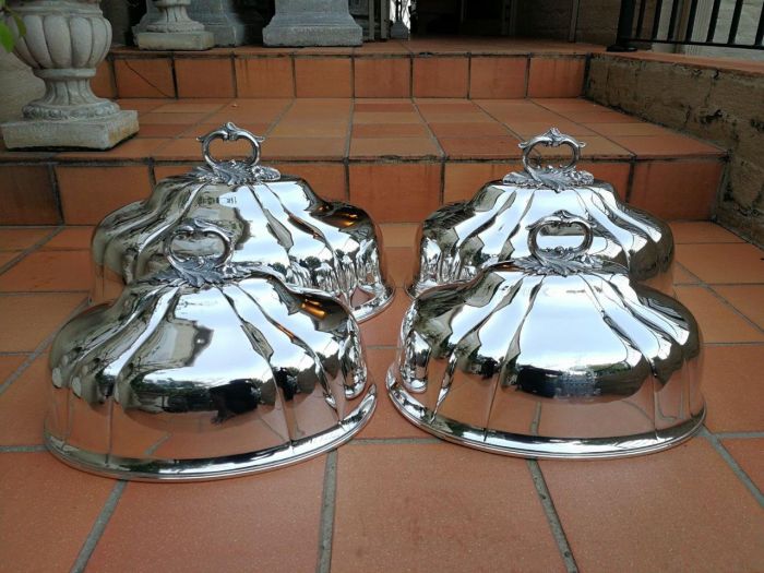 A Set Of Four Silver-Plate Food Domes