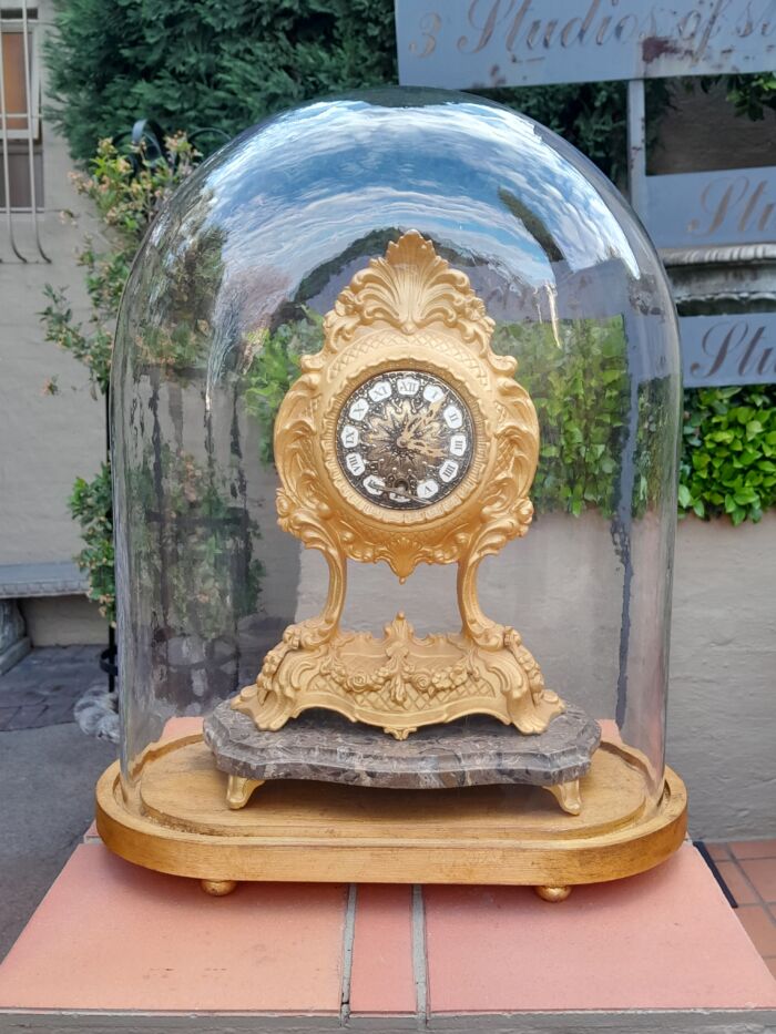 A 19th Century French Gilt Metal Clock in Glass Cloche with Hand Gilded Wooden Base