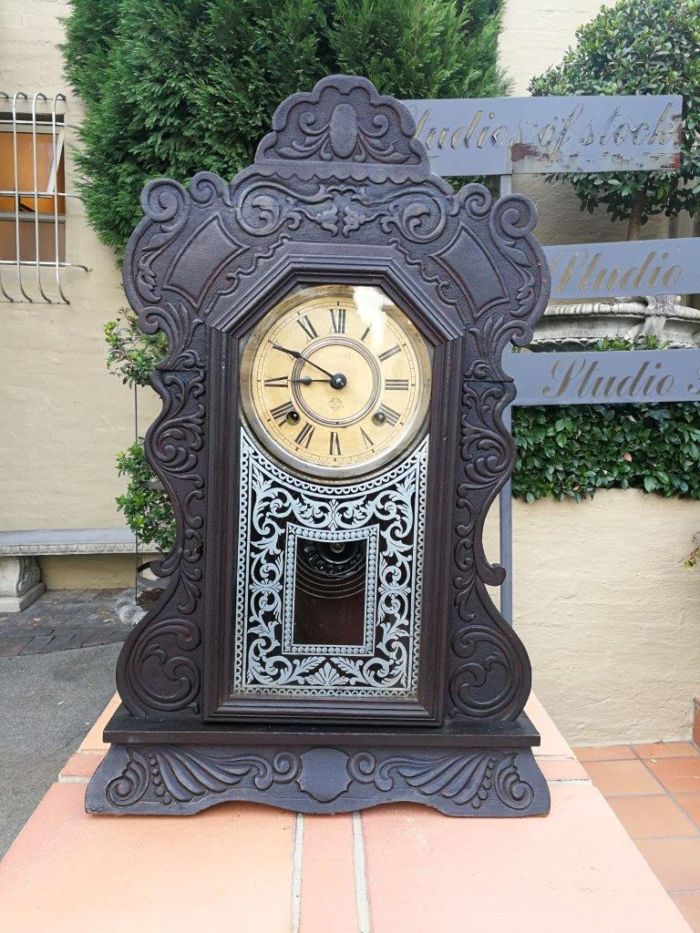 An Early 20th Century American Ebonised & Ornate Carved Oak Mantel Clock