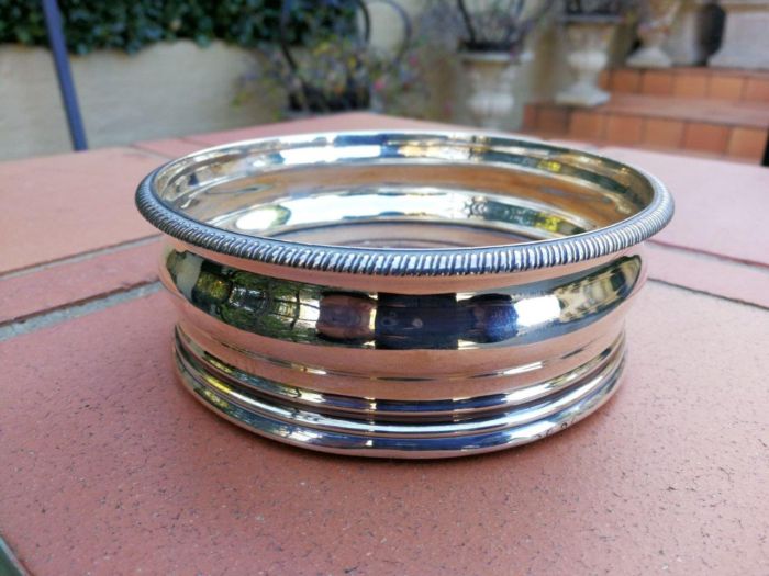 A Silver-Plated Wine Coaster with Wooden Base