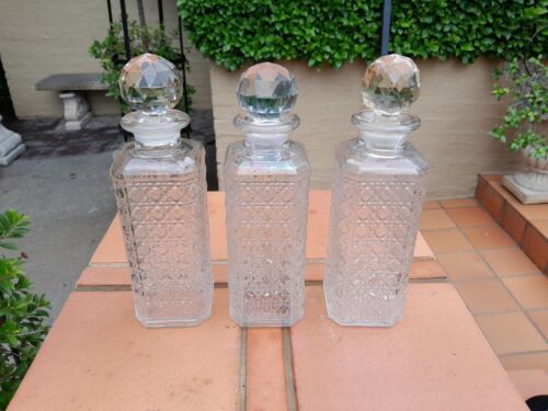 A Set of Three Glass Decanters