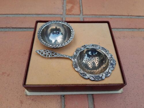 A 20TH Century Silver Plated Tea Strainer and Tea Bag Holder in a Bo