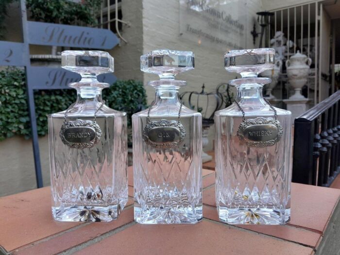 A Set Of Three Cut Glass Decanters With Labels (Whisky