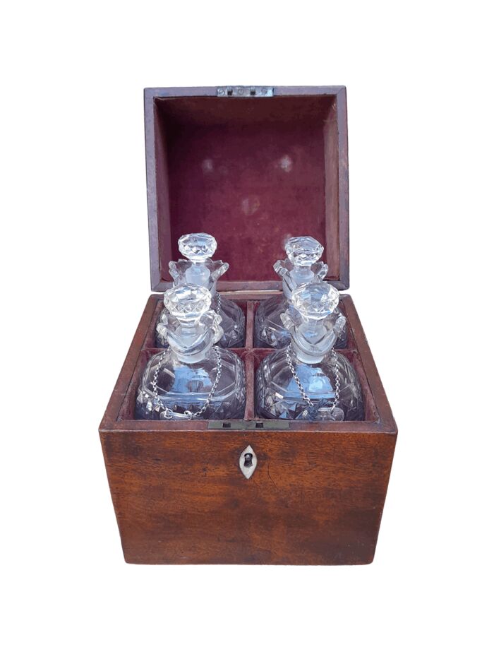 An 18th / Early 19th Century Georgian Mahogany Tantalus With Four Cut Glass Decanters And Three Georgian London Silver Wine Labels