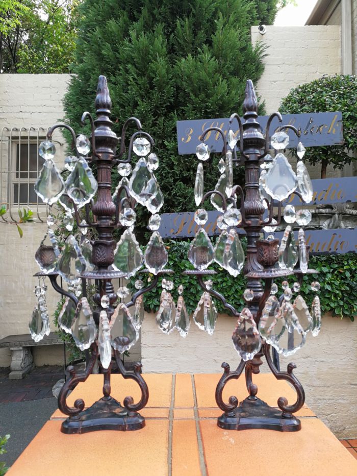 A pair of cast-iron and crystal candelabras