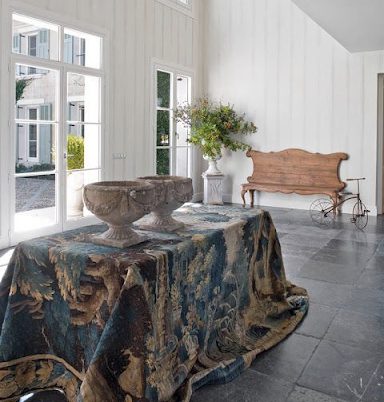 An antique tapestry can move from being an artwork on the wall to function as a table covering