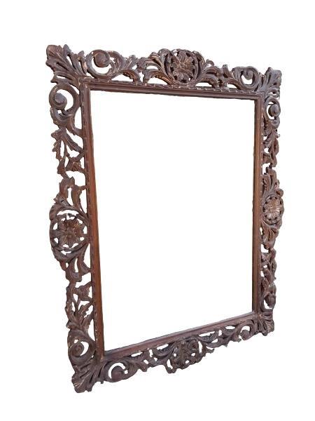 A 20TH Century Bevelled Mirror In An Ornately Carved Wooden Frame