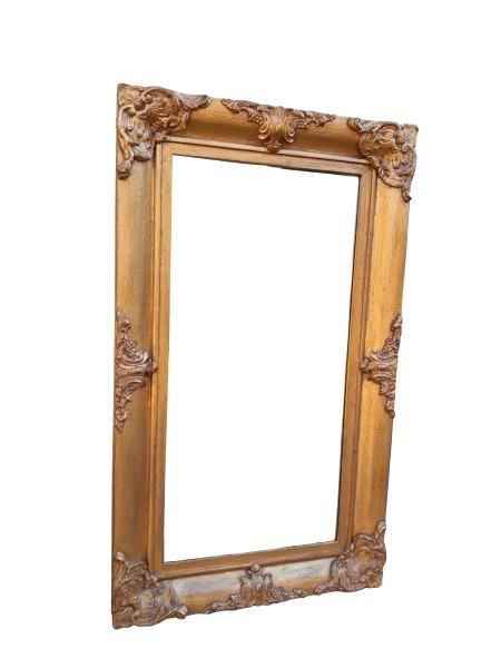 A 20th Century Ornately Carved Giltwood And Bevelled Mirror